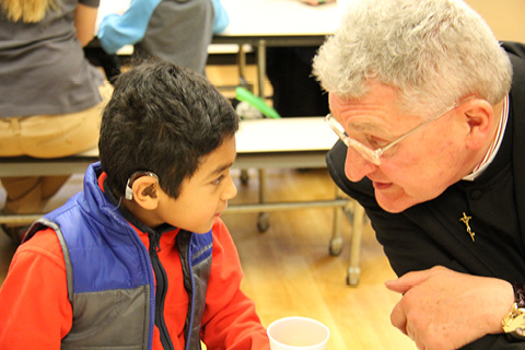 Bishop Zubik shares a smile with a student at the DePaul School for Hearing and Speech.